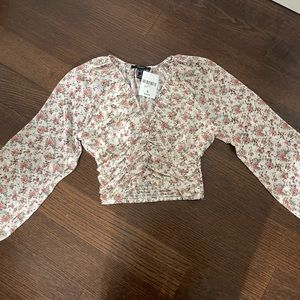 Brand new Forever 21 long sleeve flower print blouse size S.